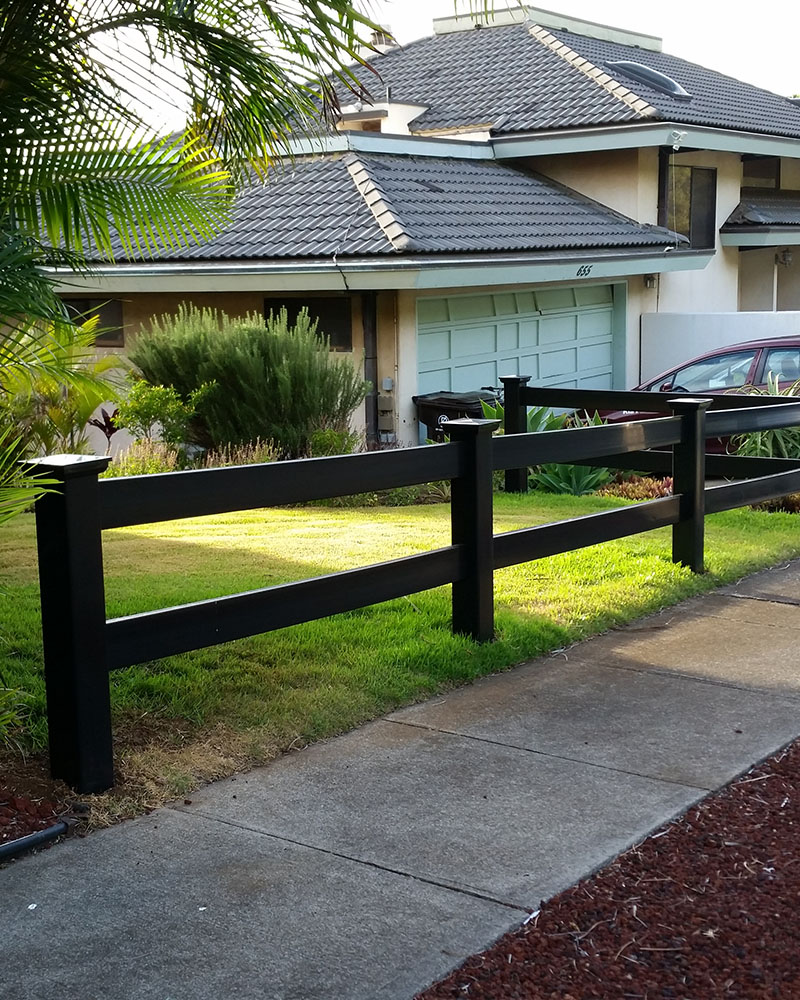 2-rail black vinyl fence in front yard