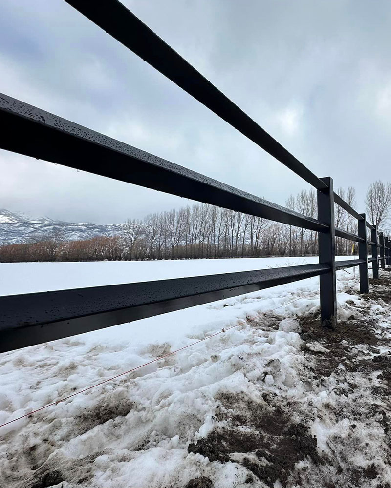 Diamond rail black vinyl fence in snowy conditions