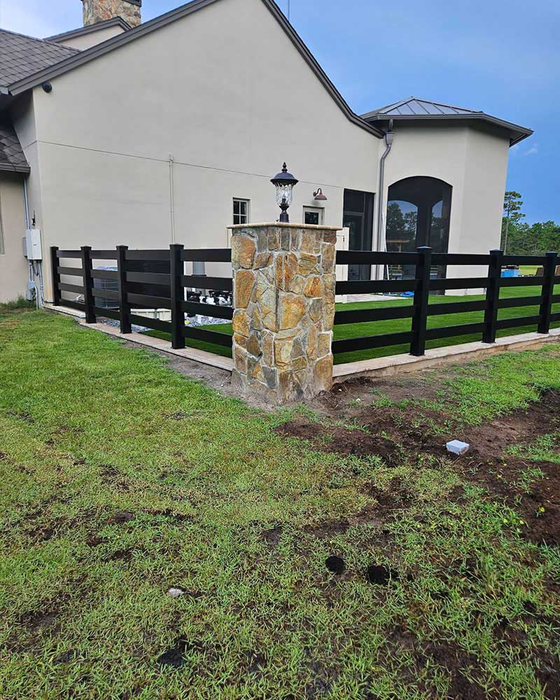 4-rail black vinyl fence with masonry columns