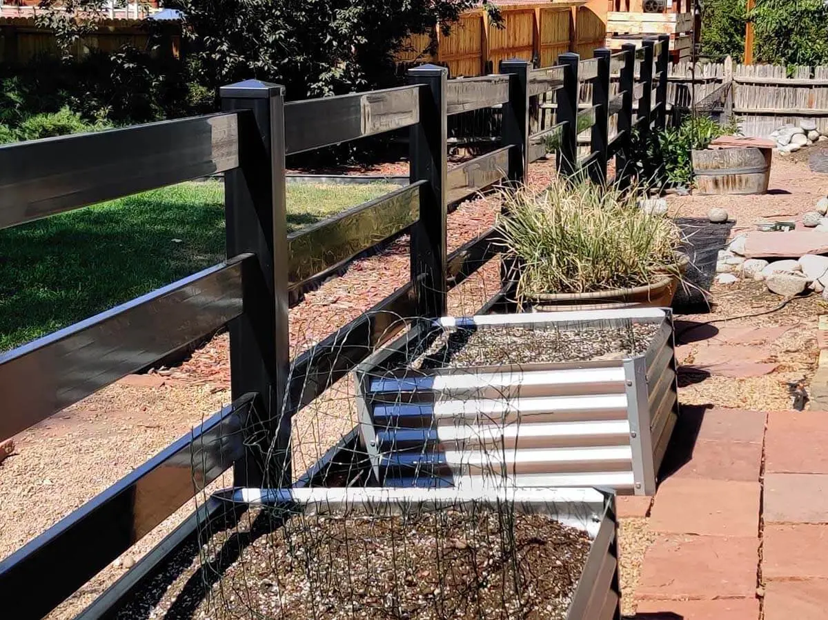 3 rail black vinyl ranch fence installed on a residential property
