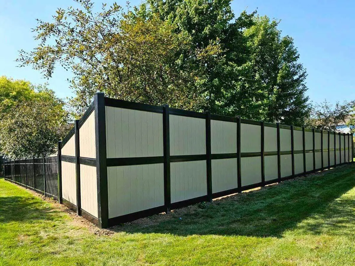 8 foot high solid privacy vinyl fence with tan infill and black posts and rails