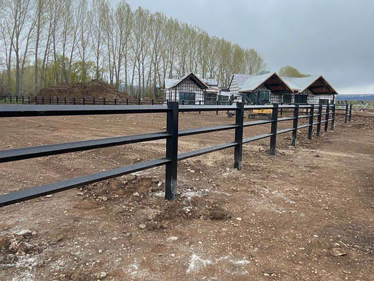Diamond ranch rail vinyl fence installed around a horse pasture
