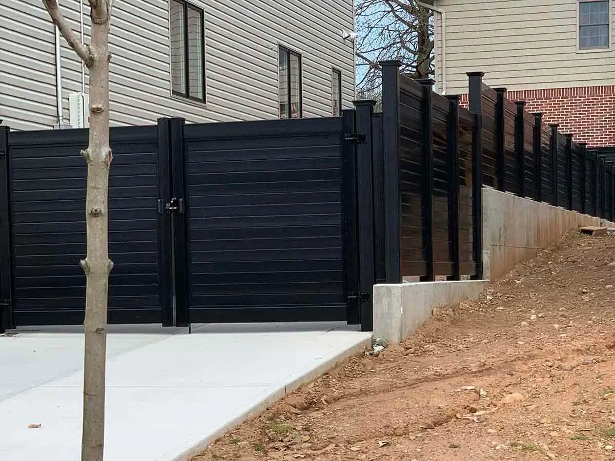 Black vinyl horizontal privacy fence and double swing gate with lock
