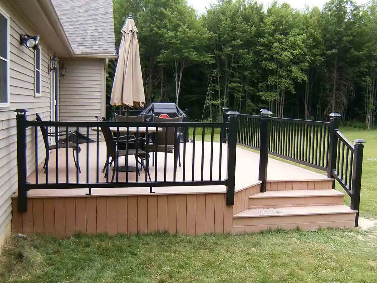 2 rail black vinyl railings installed around the edge of a front patio for a home